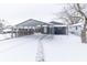 Exterior view of carport and backyard in the snow at 1704 Nelson Ave, Indianapolis, IN 46203