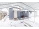 Rear view of house with carport in snowy backyard at 1704 Nelson Ave, Indianapolis, IN 46203