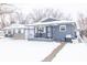 Gray house with snow covered front yard and porch at 1704 Nelson Ave, Indianapolis, IN 46203