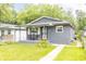 Charming home featuring a covered front porch and a well-manicured lawn, perfect for curb appeal at 1704 Nelson Ave, Indianapolis, IN 46203