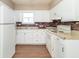 Kitchen with white cabinets and brick backsplash at 1704 Nelson Ave, Indianapolis, IN 46203
