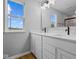 Modern bathroom featuring a dual sink vanity, modern fixtures, and natural light from a window at 1705 Real St, Indianapolis, IN 46240