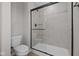 Bathroom featuring a glass-enclosed shower with a tile surround and modern fixtures at 1705 Real St, Indianapolis, IN 46240