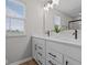 Bathroom with dual vanities, white cabinets, quartz countertops, and modern fixtures at 1705 Real St, Indianapolis, IN 46240