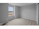Bright bedroom features neutral carpet, gray walls, and a window view at 1705 Real St, Indianapolis, IN 46240