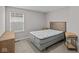 Bright bedroom features plush carpet, side tables, and a sunny window at 1705 Real St, Indianapolis, IN 46240