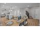 This open dining area features stylish decor, wood floors, and seamless transition into the modern kitchen with a center island at 1705 Real St, Indianapolis, IN 46240