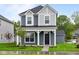 Charming two-story home with a covered front porch and well-manicured lawn at 1705 Real St, Indianapolis, IN 46240