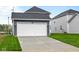The home features a two-car garage and a well-maintained front yard, blending comfort and curb appeal at 1705 Real St, Indianapolis, IN 46240