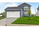 Charming home with a two-car garage, well-maintained lawn, and appealing curb appeal at 1705 Real St, Indianapolis, IN 46240