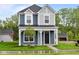 Charming two-story home with a covered front porch and well-manicured lawn at 1705 Real St, Indianapolis, IN 46240