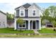 Charming two-story home with a covered front porch and well-manicured lawn at 1705 Real St, Indianapolis, IN 46240