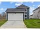 Exterior featuring a two car garage and driveway at 1705 Real St, Indianapolis, IN 46240