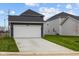 Exterior featuring a two car garage and a driveway at 1705 Real St, Indianapolis, IN 46240