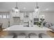 Modern kitchen featuring white cabinets, stainless steel appliances, and a spacious island with seating at 1705 Real St, Indianapolis, IN 46240