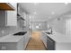 Well-lit kitchen featuring white cabinets, quartz countertops, and stainless steel appliances at 1705 Real St, Indianapolis, IN 46240