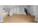 Open-concept living space with wood floors, recessed lighting, and a staircase at 1705 Real St, Indianapolis, IN 46240