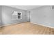 Bright living room featuring light wood flooring, a large window and fresh, neutral paint at 1705 Real St, Indianapolis, IN 46240