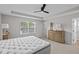 Sunlit main bedroom with ceiling fan, neutral colors, and large window at 1705 Real St, Indianapolis, IN 46240