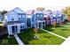 Row of colorful two-story houses with front porches at 1709 Real St, Indianapolis, IN 46240