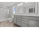 Bright bathroom featuring a double vanity, quartz countertop, and modern, glass-enclosed marble shower at 1709 Real St, Indianapolis, IN 46240