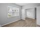 Bright bedroom featuring a large window with blinds and luxury vinyl plank flooring at 1709 Real St, Indianapolis, IN 46240