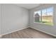 Neutral vinyl flooring, large double hung window, and fresh paint make this bedroom a relaxing space at 1709 Real St, Indianapolis, IN 46240