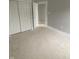 A view of the bedroom featuring a closet and doors leading to other rooms and an unfinished floor at 1709 Real St, Indianapolis, IN 46240