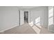 Bright bedroom features neutral carpet, closet and access to the next room in a freshly painted interior at 1709 Real St, Indianapolis, IN 46240