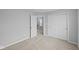 Bright bedroom featuring carpeted floors, double door closet, and natural light at 1709 Real St, Indianapolis, IN 46240