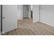Light-filled room features luxury vinyl flooring, neutral paint and multiple doors at 1709 Real St, Indianapolis, IN 46240