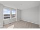 This bedroom has neutral colored carpet, fresh gray paint and a large double-hung window at 1709 Real St, Indianapolis, IN 46240
