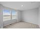 Bright bedroom featuring carpeted floors, and natural light from large windows at 1709 Real St, Indianapolis, IN 46240