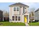 Charming two-story home with light gray siding, white trim, bright yellow door and manicured lawn at 1709 Real St, Indianapolis, IN 46240