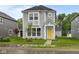 Charming two-story home with a bright yellow front door and well-manicured lawn at 1709 Real St, Indianapolis, IN 46240
