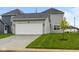 Exterior view of home with a two-car garage, paved driveway and manicured lawn at 1709 Real St, Indianapolis, IN 46240