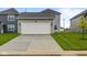 Exterior shot of a two-car garage with a paved driveway and manicured lawn at 1709 Real St, Indianapolis, IN 46240