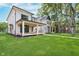 View of a large backyard with a covered porch and mature trees surrounding the property at 1822 Central Ave, Indianapolis, IN 46202