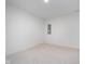 Simple bedroom featuring neutral carpet, white walls, recessed lighting, and a small window at 1822 Central Ave, Indianapolis, IN 46202