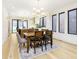 Bright dining room featuring wood floors, chandelier lighting, and a stylish rug at 1822 Central Ave, Indianapolis, IN 46202