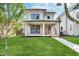 Stunning two-story home featuring a covered front porch and lush green lawn at 1822 Central Ave, Indianapolis, IN 46202