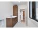 Laundry room with stainless steel sink and dark wood cabinets with modern hardware at 1822 Central Ave, Indianapolis, IN 46202