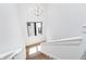 Bright staircase features a modern chandelier, natural light, and white painted walls at 1822 Central Ave, Indianapolis, IN 46202