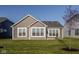 Spacious backyard with a well-maintained lawn, neutral siding, and bright white windows at 19629 Astoria Ave, Sheridan, IN 46069