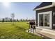 Patio with a grill looking out to a beautiful green yard and tree-lined street at 19629 Astoria Ave, Sheridan, IN 46069