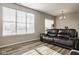 Spacious living room featuring a leather couch and large windows with lots of natural sunlight at 19629 Astoria Ave, Sheridan, IN 46069