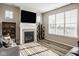 Inviting living room with a cozy fireplace, large TV, and plenty of natural light from the window at 19629 Astoria Ave, Sheridan, IN 46069