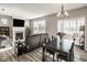 Open concept living and dining area featuring a chandelier, fireplace, and neutral color palette at 19629 Astoria Ave, Sheridan, IN 46069