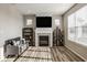 Comfortable living room featuring a fireplace, built-in shelving, and large windows with lots of light at 19629 Astoria Ave, Sheridan, IN 46069