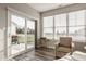 Bright sunroom with slider to the back and large windows with backyard views and plenty of light at 19629 Astoria Ave, Sheridan, IN 46069